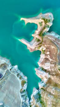 Stunning aerial view of a vibrant turquoise coastal landscape with unique geological formations.