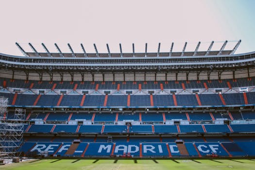 Empty stands of Santiago Bernabéu Stadium in Madrid, showcasing Real Madrid CF's seats.