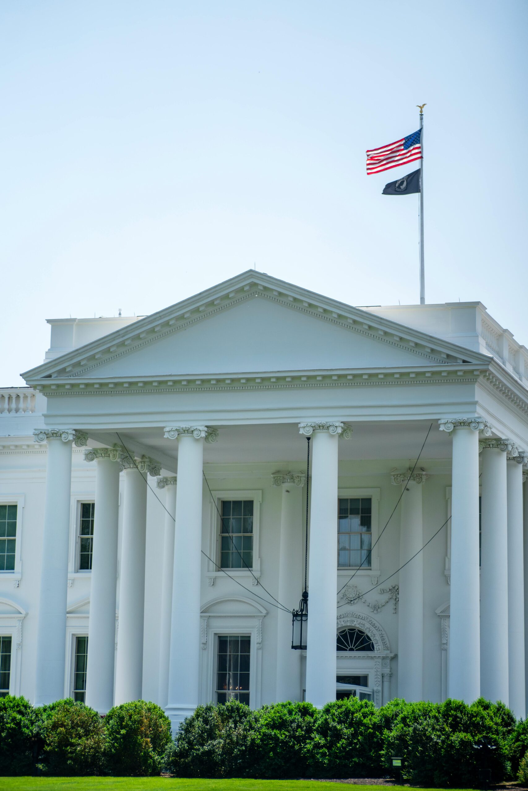 A close-up view of the White House with American flag on a sunny day.