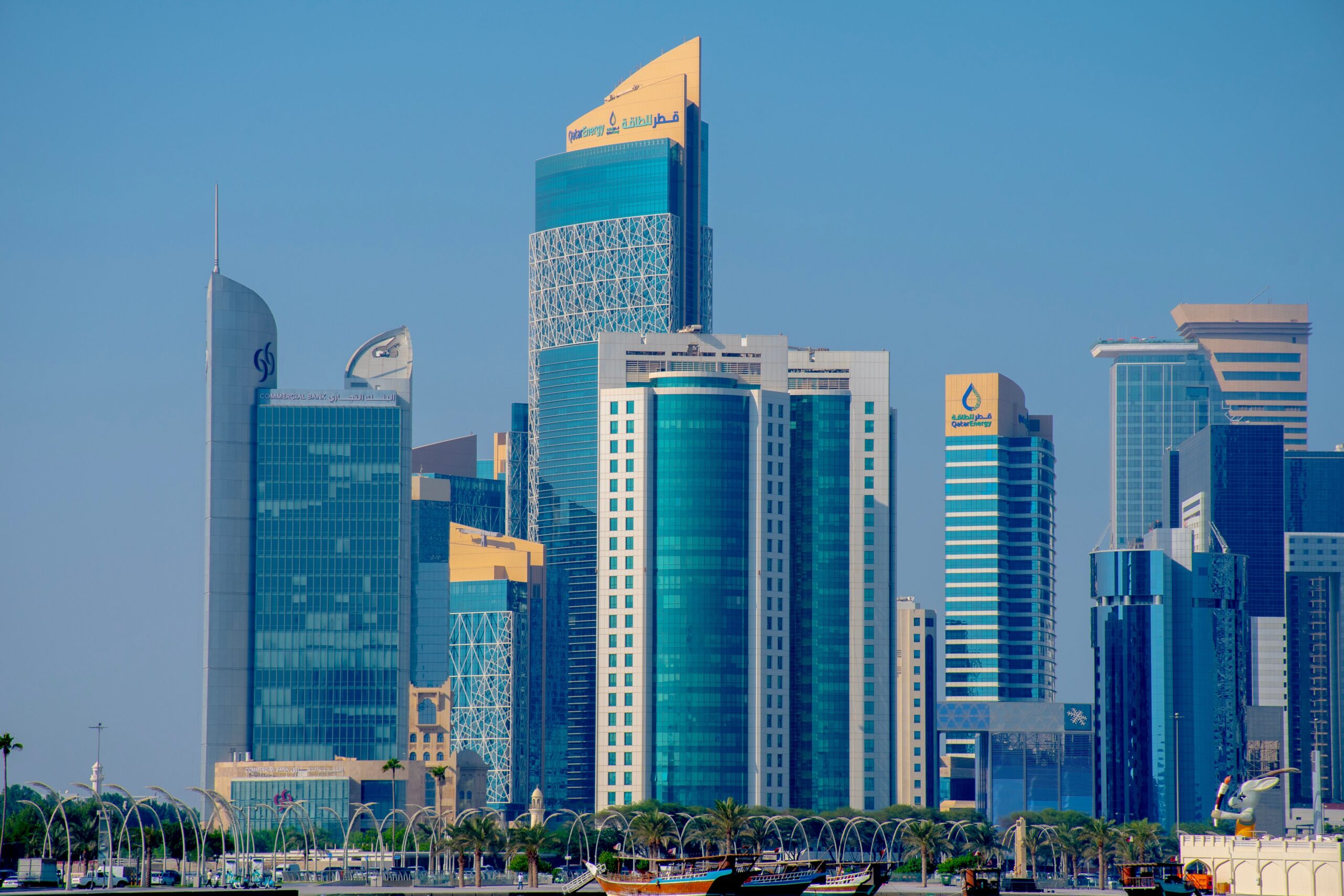 A vibrant view of Doha's modern skyline against a clear blue sky.