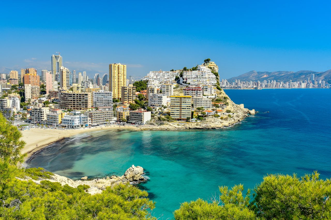 A beautiful coastal view of Benidorm's skyline with vibrant turquoise waters and modern architecture.